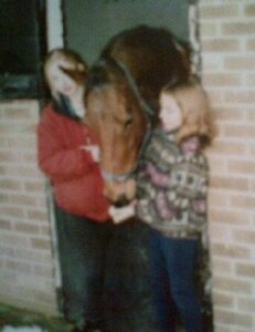 Ruby and horse in field together