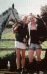 Ruby and horse in field together